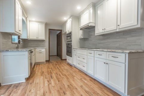 New shaker style white cabinets and recessed lighting in Davis kitchen remodel