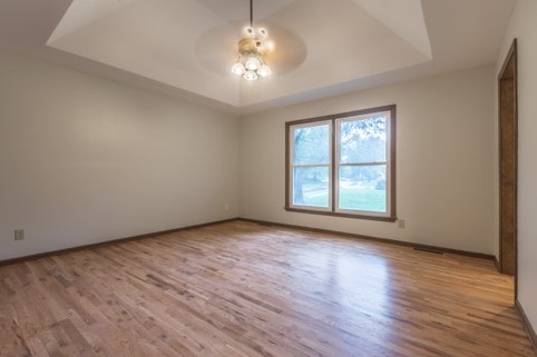 Master bedroom with a recessed or tray ceiling