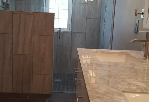 Grey bathroom with tile and half wall