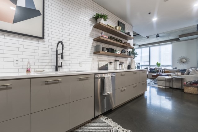 Kitchen condo style grey cabinets and floating shelving