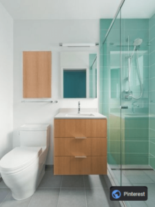 Shower with green glass, floating vanity and tiny toilet