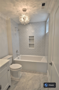 Small bathroom lighting exceptional with light grey tile.