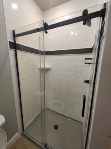 shower with onyx surround and black inlay